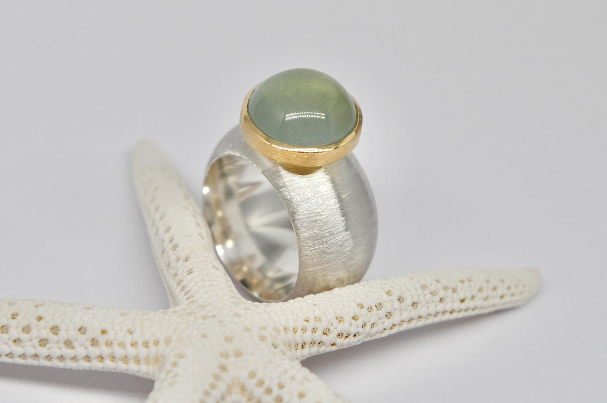 Silver, 18k yellow gold, aquamarine cabochon