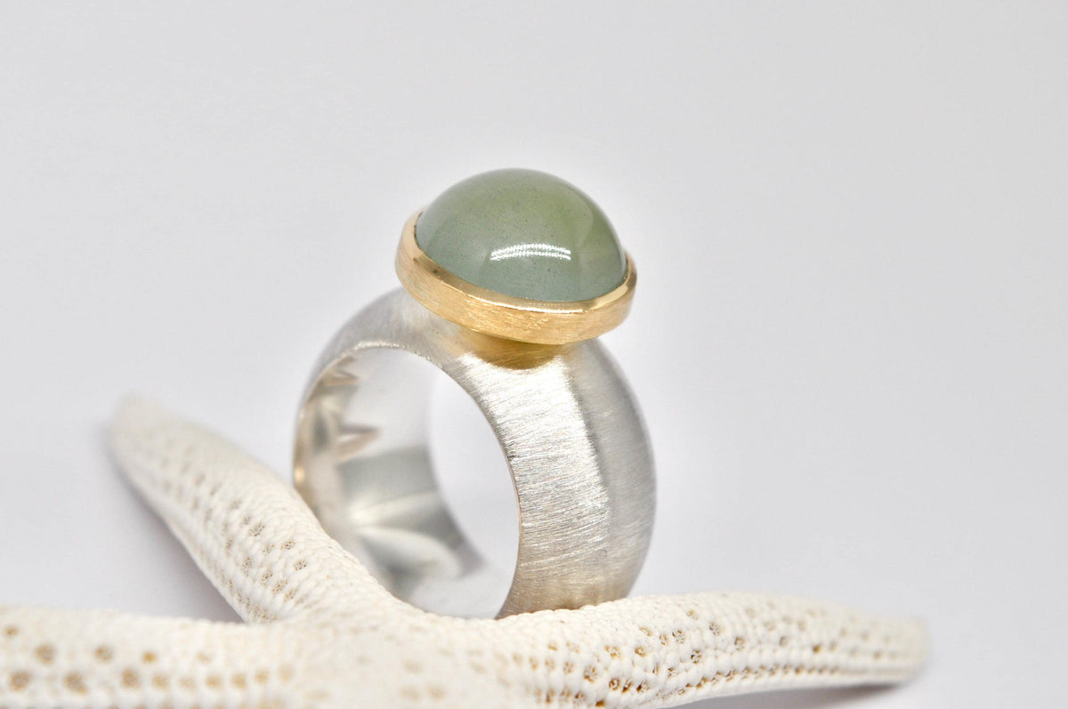 Silver, 18k yellow gold, aquamarine cabochon