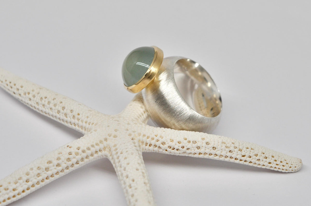Silver, 18k yellow gold, aquamarine cabochon