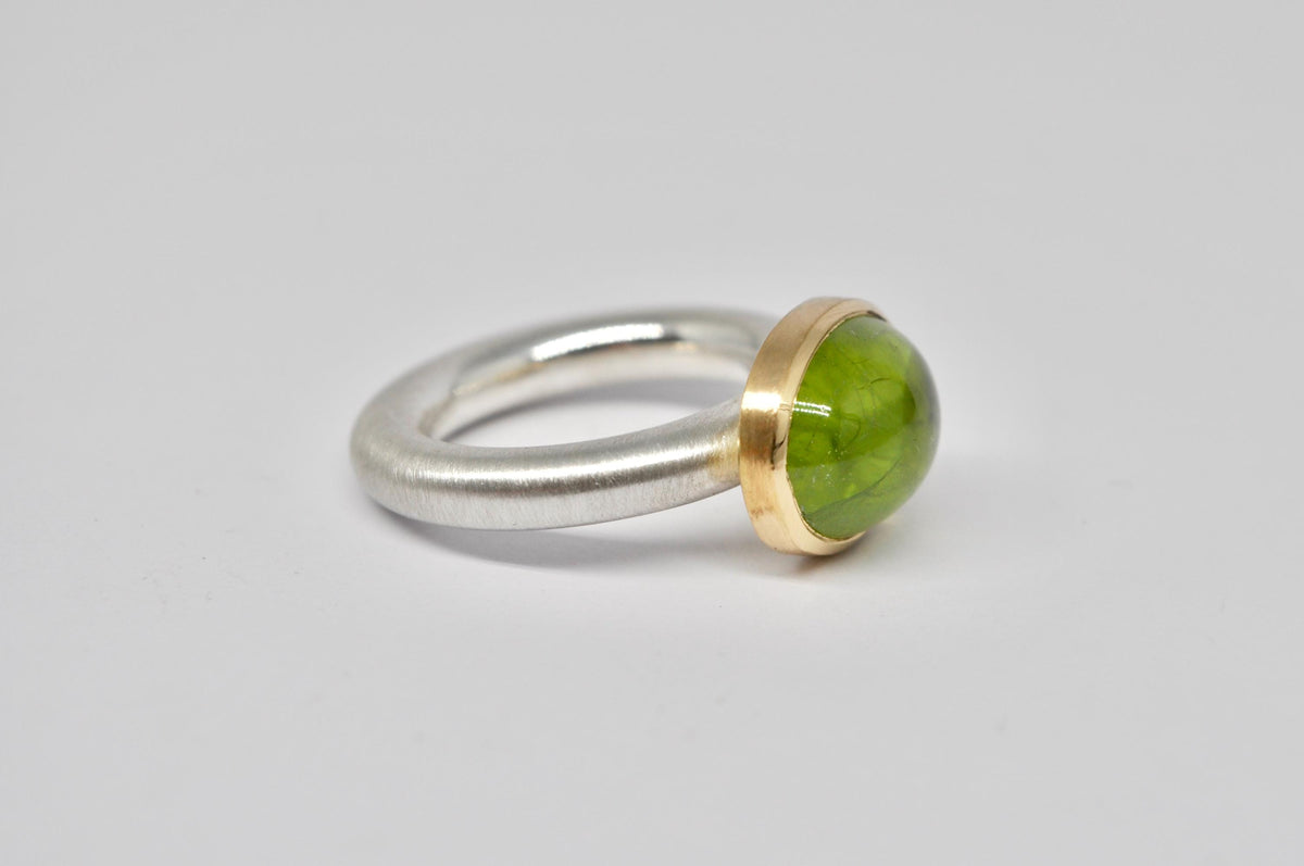Silver and gold ring with peridot cabochon